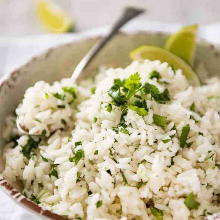 Coconut Cilantro Lime Rice in a bowl with a spoon, ready to be served.