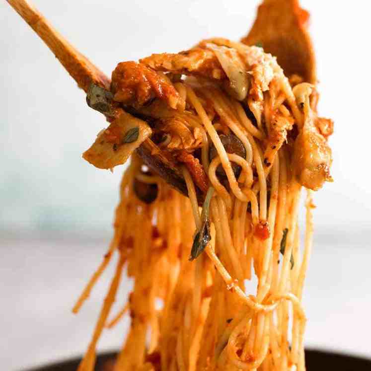 Sicilian Chicken Spaghetti being tossed in sauce