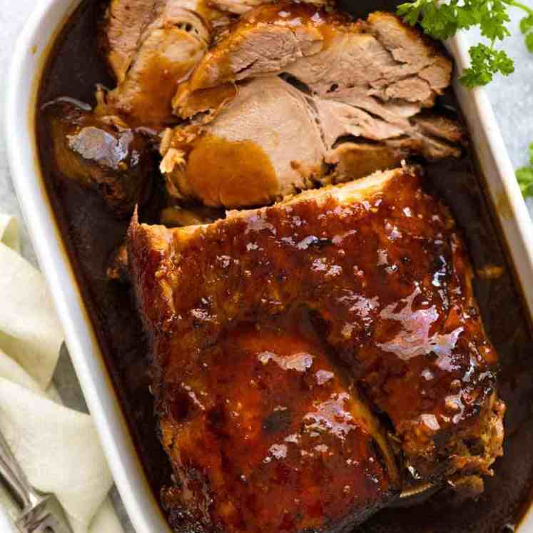 Slow Cooker Pork Loin Roast in a white dish, ready to be served