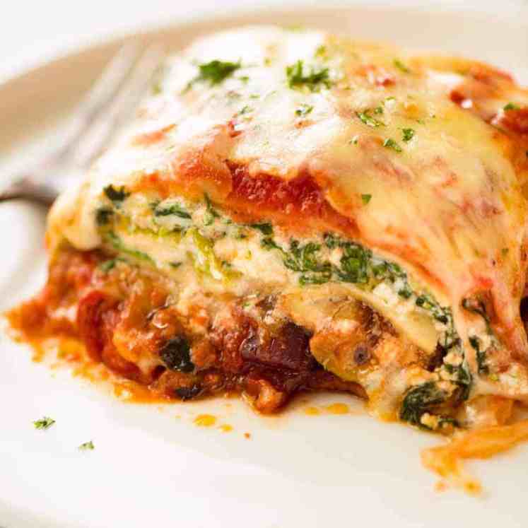 Close up of Vegetarian Lasagna on a white plate, ready to be eaten